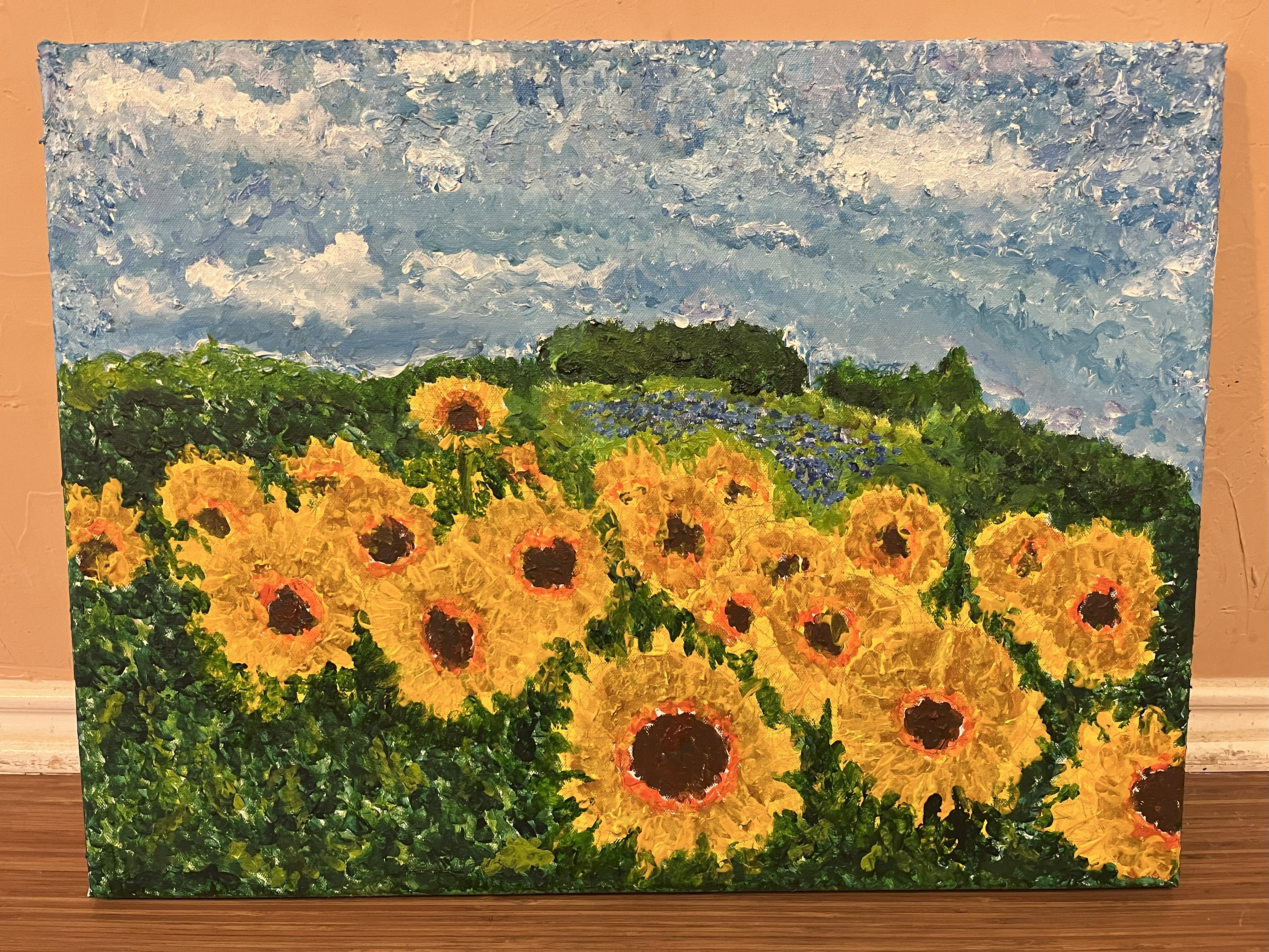 A field of sunflowers and bachelor buttons